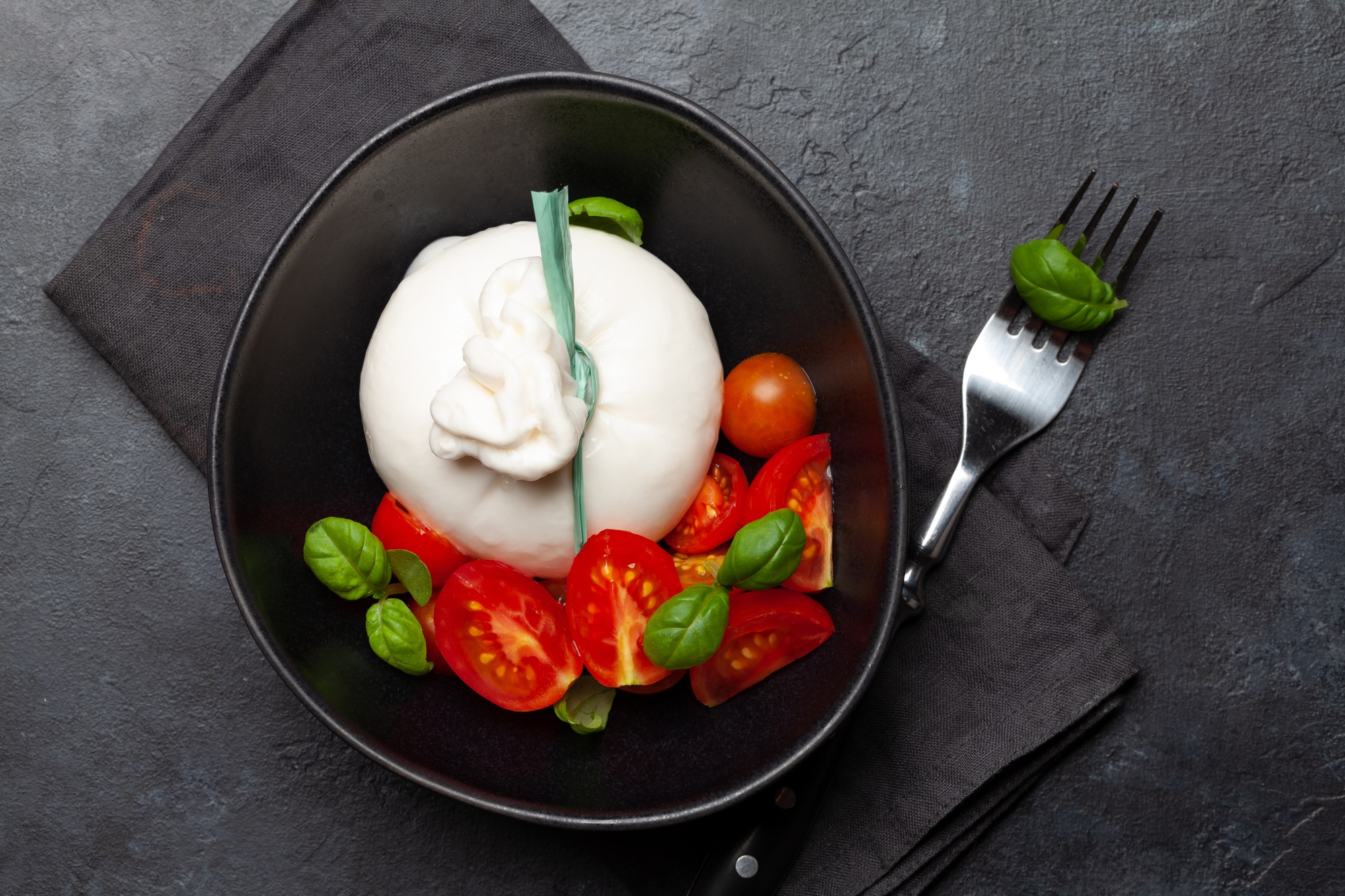 Burrata cheese, various tomatoes and olives